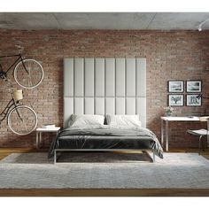 a bedroom with brick walls and a bicycle mounted to the wall above the headboard