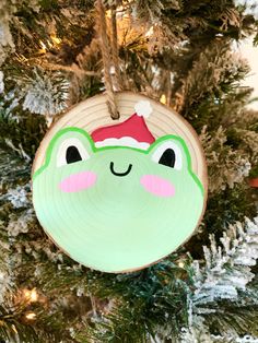 a green ornament hanging from a christmas tree