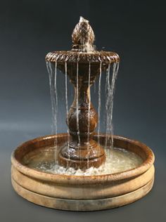 a fountain with water spouting out of it's sides and on top