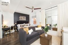 a living room filled with furniture and a ceiling fan