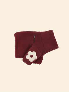 a pair of red gloves with a flower on the front and side, both made out of