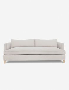 a white couch sitting on top of a wooden floor