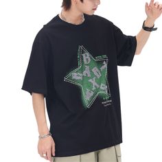 Introducing the Star Letter Graphic Cotton T-shirt, a perfect blend of comfort, style, and individuality. Crafted with the finest quality materials and attention to detail, this t-shirt is designed to make a bold statement wherever you go. Features: -100% Cotton -Crew neckline -Star graphic front -Regular fit -Unisex style Casual Black T-shirt With Star Print, Trendy Star Print T-shirt For Streetwear, Trendy Star Print Streetwear T-shirt, Casual Star Print T-shirt For Streetwear, Black Cotton Tops With Star Print, Trendy Relaxed Fit T-shirt With Star Print, Black Cotton Top With Star Print, Black Star Print Casual T-shirt, Black Casual T-shirt With Star Print