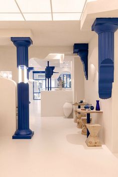 a white room with blue columns in it