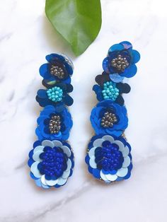 This beaded blue sequin flower earring scream wow and absolutely beautiful. Has 4 drop flowers with beaded sequin. Length: 3 inches long Blue 3d Flower Drop Earrings, Blue Bohemian Flower Earrings For Party, Blue Beaded Dangle Flower Earrings, Beaded Dangle Flower Earrings For Party, Blue Drop Flower Earrings For Party, Handmade Blue Flower Earrings For Party, Blue Dangle Flower Earrings For Party, Blue Handmade Flower Earrings, Handmade Blue Flower Earrings