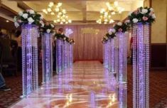 an aisle decorated with purple and white flowers