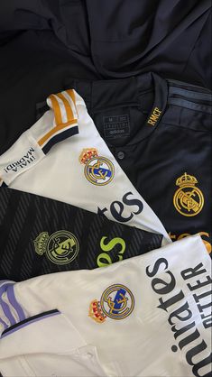 several different soccer jerseys laying on top of each other