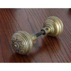 an antique brass door knob on a wooden table