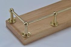 a close up of a wooden shelf with brass hardware on it's sides and two handles