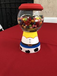 a gummy machine sitting on top of a red table