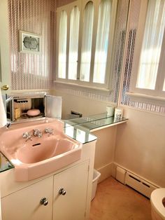 a bathroom with a sink, mirror and toilet