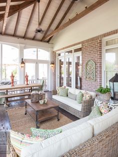 a living room filled with furniture and lots of windows