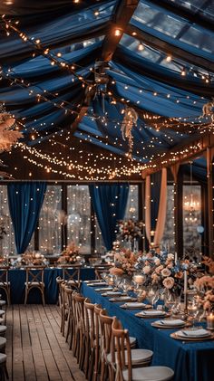 an indoor dining area with blue drapes and lights