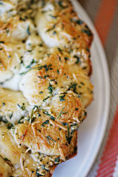 a white plate topped with pizza covered in cheese