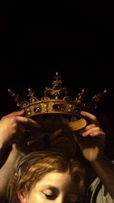 a man holding a crown over his head