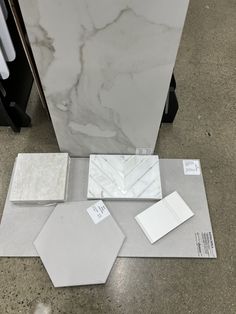 some white marble tiles are laying on the floor