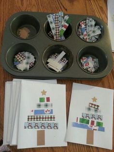 cupcake tins are decorated with christmas trees and paper napkins on the tray