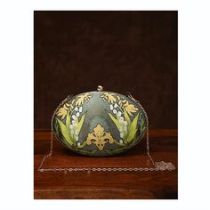 This is one of a kind handcrafted bag which is handcrafted to order. As it is a handcrafted product, it may have slight irregularities or imperfections.  MEASUREMENTS Length - 17.78cm Width - 22.86cm Handle - 57.15cm This clutch can be worn as a crossbody bag or a shoulder bag with the sling chain or can simply be carried in hand. It is spacious enough to carry mobile phones, cosmetics, keys and other small accessories. Unique Handmade Evening Bags, Unique Evening Clutch Bag, Handmade Pouch Shoulder Bag For Formal Occasions, Handmade Formal Pouch Shoulder Bag, Handmade Pouch Evening Bag For Gift, Unique Green Bag As A Gift, Handheld Handmade Bag For Formal Occasions, Unique Green Bag For Gift, Elegant Hand Painted Rectangular Bag