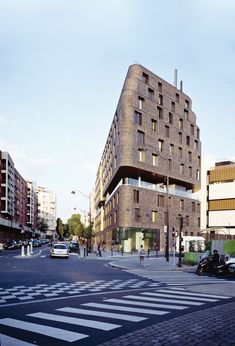 a large brick building sitting on the side of a road next to a traffic light