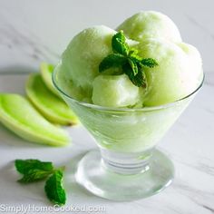 a glass bowl filled with green ice cream