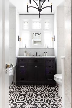 a bathroom with black and white tile flooring