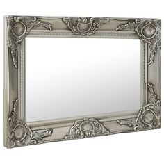 This beautifully designed wall mirror with an ornate frame creates a classic atmosphere in your dressing room. The antique-look mirror features a sturdy wooden frame that is meticulously crafted in a decorative Baroque pattern. Additionally, the beveled edge gives this mirror a unique look. The mirror is ready to be wall-mounted thanks to the already installed hooks on the backboard. Color: Silver Material: Wood, glass and engineered wood Dimensions: 23.6" x 15.7" (L x W) Mirror shape: Rectangle With mounting hooks Designed Wall, Silver Wall Mirror, Baroque Pattern, Style Baroque, Glas Art, Mirror Shapes, Baroque Style, Ornate Frame, Baroque Fashion