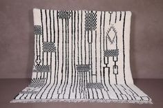 a black and white rug with fringes on it