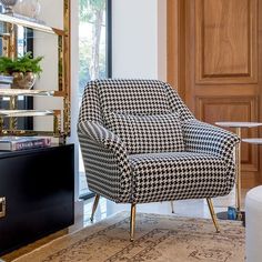 a black and white chair sitting on top of a rug