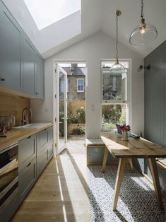 an open kitchen and dining area with skylights