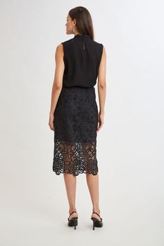 Reach for our Crochet Lace Midi Skirt for a sophisticated, fresh Fall look. The beautiful, scalloped hem is accented by the shorter lining for a glimpse of leg. Dress it down with a vegan leather jacket or cashmere or up with Satin. Limited Edition 50th Anniversary Collection Elie Tahari Exclusive Crochet Lace Midi Skirt 100% Polyester Runs true to Size Length From Waist to Hem: Back 30.25"L (approx. length for size 6) Model is 5'9" and wearing size 2 Dry Clean Only Imported Style #: E905R304 Chic Asymmetrical Skirt With Lace Trim, Elegant Summer Skirt With Cutwork Hem, Chic Summer Skirt With Cutwork Hem, Chic Party Skirt With Lace Trim, Chic Lined Pencil Skirt For Cocktail, Fitted Bottoms With Scalloped Edges For Spring, Elegant Maxi Skirt With Lace Trim, Elegant Fitted Skirt With Scalloped Lace, Elegant Fitted Scalloped Lace Skirt