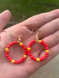 Handcrafted hoops earrings made with vibrant red gold and white beads, perfect for adding a pop of color to any outfit. Lightweight and comfortable to wear.  Material 25mm hoops 14k plated  beaded Color  Red Gold White Red Small Hoop Earrings For Summer, Red Colorful Beads Hoop Earrings, Red Hoop Earrings With Colorful Beads, Red Beaded Round Hoop Earrings, Red Hoop Jewelry With Colorful Beads, Red Hoop Earrings For Summer, Red Adjustable Hypoallergenic Hoop Earrings, Red Hypoallergenic Hoop Jewelry, Red Hypoallergenic Round Bead Earrings