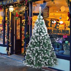 a christmas tree in front of a store