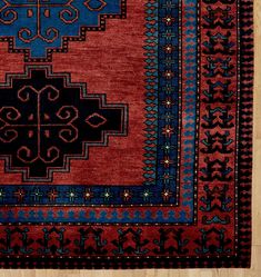 a red and blue rug with an intricate design