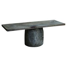 a table made out of concrete with a wooden base and metal structure on the top