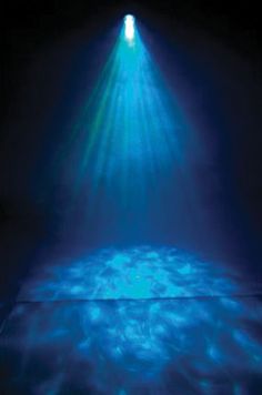 the light is shining down on the floor in the dark room with blue and green lights