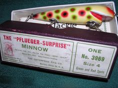 a fishing lure in a box on a green surface