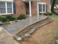 a brick house with stone steps leading to the front door