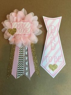 two pink and silver ribbons with the words mom to be on them