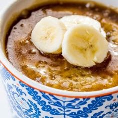 a bowl filled with oatmeal topped with banana slices