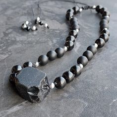 One of 9 unique handmade necklaces with raw black obsidian. It is decorated with stones with a diameter of 8 mm - polished and matt onyx. The dividers are made of silver hematites and the ends are decorated with smaller black onyx stones. All stones are 100% natural, yet it is very light and comfortable to wear. The necklace is made of a strong black string and is adjustable in length (macrame sliding knot) - it can be worn both as a long necklace and as a choker. It is waterproof - none of the Obsidian Necklace With 8mm Beads As Gift, Black Obsidian Necklace With 8mm Beads, Adjustable Obsidian Necklace With Natural Stones, Black Obsidian Necklaces For Jewelry Making, Obsidian Necklace With Natural Stones, Black Agate Spiritual Necklace, Black Lava Stone Necklace For Gift, Black Lava Stone Round Bead Necklaces, Black Agate Necklace With Black Beads