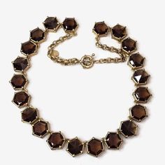 This is a Talbots hexagon shaped, faceted brown crystal necklace--a perfect blend of classic sophistication and contemporary charm. This necklace features a stunning array of 21 brown crystal set in a gold tone setting. The warm, earthy tones of the brown crystals add a touch of richness to any outfit, while the unique hexagonal shape and faceted finish catch the light for a subtle sparkle. Measures 21"l. and finished with a spring ring clasp. No damage or missing stones. Brown Crystals, Custom Jewellery, Jewellery Ideas, Crystal Set, Hexagon Shape, Earthy Tones, Gold Jewellery, Spring Rings, Pendant Necklaces