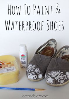 a pair of gray shoes sitting on top of a table next to paint and waterproof shoes