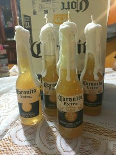 four bottles of corona beer on a table