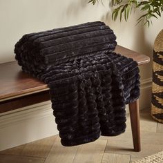 a pile of black towels sitting on top of a wooden table