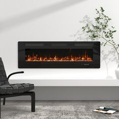 a modern fireplace in a living room with a chair and potted plant on the floor