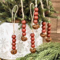 christmas ornaments hanging from a tree in a bucket