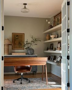 an open door leading to a home office with a desk and chair in the corner