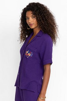 Crafted from 100% breathable cotton, the Desire Camp Shirt is embellished with intricate colorful embroidery at the front and back. Featuring a classic collared button-front, this relaxed-fit casual shirt is finished with a patch pocket at the chest. Pair with linen shorts and strappy sandals for a vibrant weekend look. Johnny Was Women's Camp Shirt in Violet Indigo Purple, Size Small, Linen/Cotton Embroidered Camp Collar Top With Relaxed Fit, Embroidered Tops With Relaxed Fit And Camp Collar, Embroidered Camp Collar Top For Beach, Embroidered Cotton Camp Collar Tops, Embroidered Cotton Tops With Camp Collar, Collared Cotton Camp Shirt, Cotton Collared Camp Shirt, Indigo Purple, Colorful Embroidery