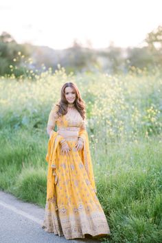 Aaradhya Lehenga can make the hidden elegance and glory come alive. This is a complete masterpiece of fancy lehenga, which has been very carefully designed using valuable mirror, pearl, stone, and embroidery work. This is completely perfect for reception and wedding wear; thus, it is an absolute must-have. Color: Sunshine Yellow Fabric and Work Style: Silk blouse with mirror, foil, sequin, and embroidery work Soft net lehenga with mirror, foil, and embroidery work Soft net dupatta with embroider Yellow Saree With Dabka Work For Wedding, Wedding Lehenga With Dabka Work In Traditional Drape, Yellow Dabka Work Saree For Wedding, Yellow Lehenga With Intricate Embroidery, Yellow Wedding Saree With Dabka Work, Traditional Drape Lehenga In Chinon With Dabka Work, Traditional Drape Lehenga With Dabka Work, Yellow Dola Silk Lehenga With Dabka Work, Dabka Work Lehenga For Reception