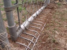 an image of a fence that has been knocked over with metal bars attached to it